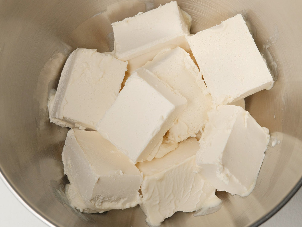Blocks of plant-based butter in a stainless-steel mixing bowl.